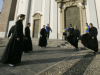 Clerics of the soccer team "priests Selecao" practice with soccer balls as they wait outside the St.Paul and Peter's church in Arluno, near Milan, Italy, prior to a training session in the nearby church playground, Thursday, Feb. 2, 2007. Moreno Buccianti, a 50-years-old amateur soccer coach from Tuscany, together with …