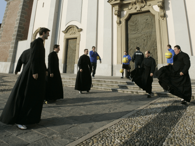 Clerics of the soccer team "priests Selecao" practice with soccer balls as they wait outsi