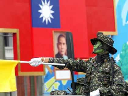 A soldier from one of Taiwan's elite special operation units, salutes atop a military truc