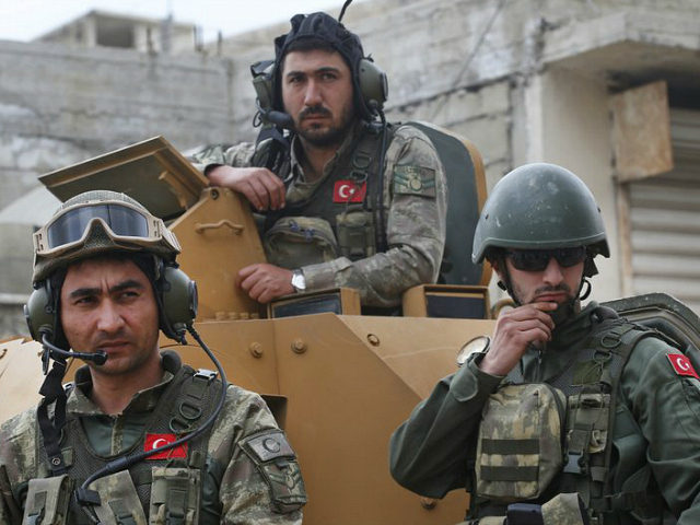 FILE - In this March 24, 2018 file photo, Turkish soldiers atop an armored personnel carri