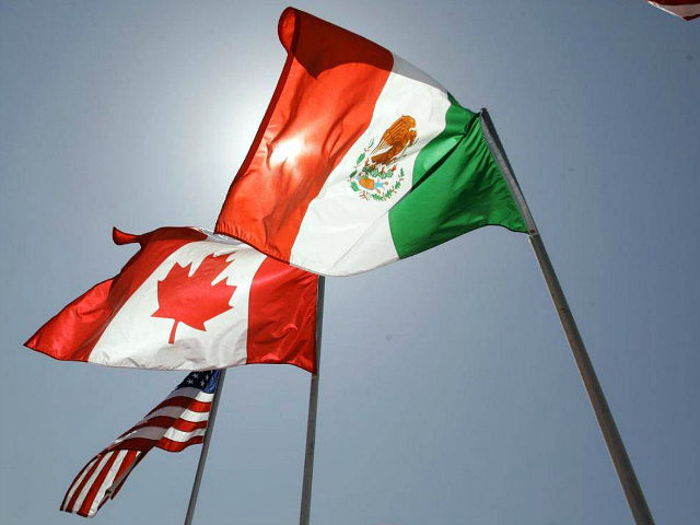 The flags of the United States, Canada and Mexico fly in the breeze at the Louis Armstrong