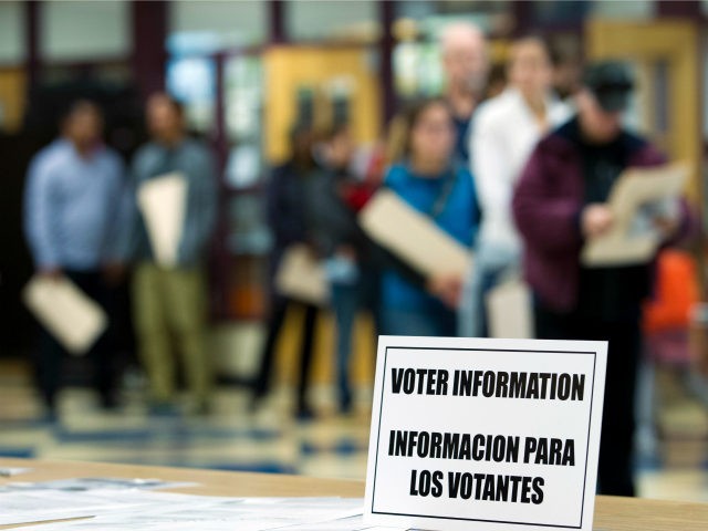 An information sign, also in Spanish, sits on the table as people wait to cast their ballots at the Takoma Park Middle School, in Takoma Park, Md., Tuesday, Nov. 8, 2016. ( AP Photo/Jose Luis Magana)