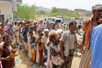 Yemenis displaced by the war ravaging their country line up to receive food aid from the Red Crescent on September 1, 2018