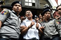 Myanmar journalist Wa Lone of Reuters is escorted by police after being sentenced with his colleague Kyaw Soe Oo to seven years in jail over their reporting on a 2017 massacre of Rohingya Muslims