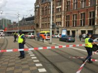 Security officials cordon off an area outside the Central Railway Station in Amsterdam following an attack by a knife-wielding man who wounded two American tourists.