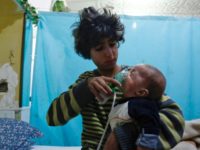 A Syrian boy holds an oxygen mask over the face of an infant at a makeshift hospital in the rebel-held Eastern Ghouta town of Douma outside Damascus on January 22, 2018 after a reported gas attack Chemical weapons attacks in Syria's war: a timeline