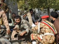 Soldiers and a Muslim cleric take cover during an attack on a military parade in the Iranian city of Ahvaz on September 22, 2018 Soldiers and a Muslim cleric take cover during an attack on a military parade in the Iranian city of Ahvaz on September 22, 2018