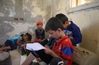 Displaced Syrian children attend class at a makeshift school in an opposition-held area in the west of the northern province of Aleppo