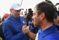 Francesco Molinari (R) gets a well-deserved handshake from skipper Thomas Bjorn after picking up a maximum five points