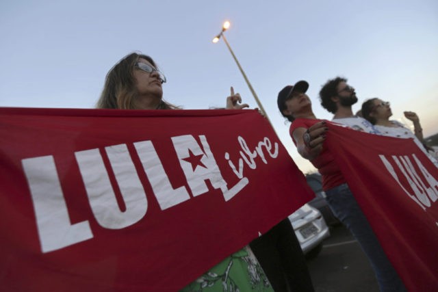 Brazil Elections Supporters of Brazil's Former President Luiz Inacio Lula da Silva, display banners with text written in Portuguese that read "Free Lula" during during a protest in front of the Superior Electoral Court, as the trial against the candidacy of the jailed former president continues, in Brasilia, Brazil, Friday, Aug. 31, 2018. Brazil's general elections will be held on October 7. (AP Photo/Eraldo Peres) The Associated Press
