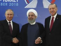 APTOPIX Iran Turkey Russia Syria Iran's President Hassan Rouhani, centre, flanked by Russia's President Vladimir Putin, left, and Turkey's President Recep Tayyip Erdogan, pose for photographs in Tehran, Iran, ahead of their summit to discuss Syria, Friday, Sept. 7, 2018. The three leaders began a meeting to discuss the war in Syria.(Presidential Press Service via AP, Pool) The Associated Press