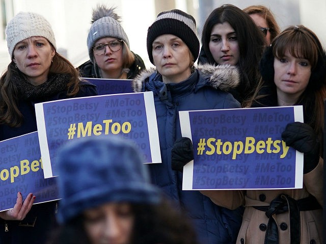 WASHINGTON, DC - JANUARY 25: Activists hold signs during a news conference on a Title IX l