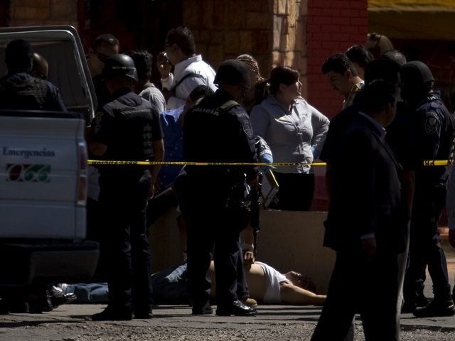 A man lies dead on the street after being shot by city police in Tijuana, Mexico. (AP File