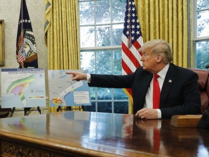 President Donald Trump points towards maps while discussing potential damage from Hurricane Michael with Homeland Security Secretary Kirstjen Nielsen and FEMA Administrator Brock Long in the Oval Office of the White House in Washington, Wednesday, Oct. 10, 2018. (AP Photo/Pablo Martinez Monsivais)