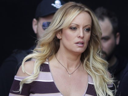 Adult film actress Stormy Daniels, front, arrives for the opening of the adult entertainme