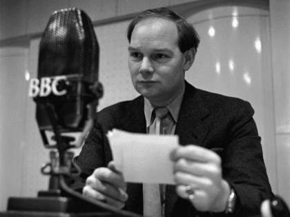 4th January 1956: BBC Radio presenter, Cliff Michelmore, reads a request during a recordin