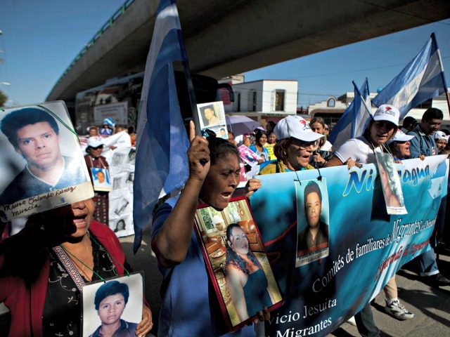 Members of a caravan of Central American mothers hold photographs of their disappeared chi