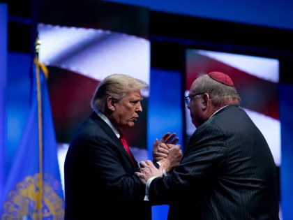 President Donald Trump talks with Rabbi Benjamin Sendrow after he prayed at the 91st Annual Future Farmers of America Convention and Expo at Bankers Life Fieldhouse in Indianapolis, Saturday, Oct. 27, 2018, following a shooting in a Pittsburg synagogue. (AP Photo/Andrew Harnik)