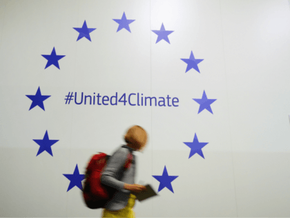 BONN, GERMANY - NOVEMBER 07: A participant walks past European Union stars advertising an EU social media climate intiative in Bonn Zone at the COP 23 United Nations Climate Change Conference on November 7, 2017 in Bonn, Germany. The conference brings together 25,000 participants to discuss climate change-related issues and …