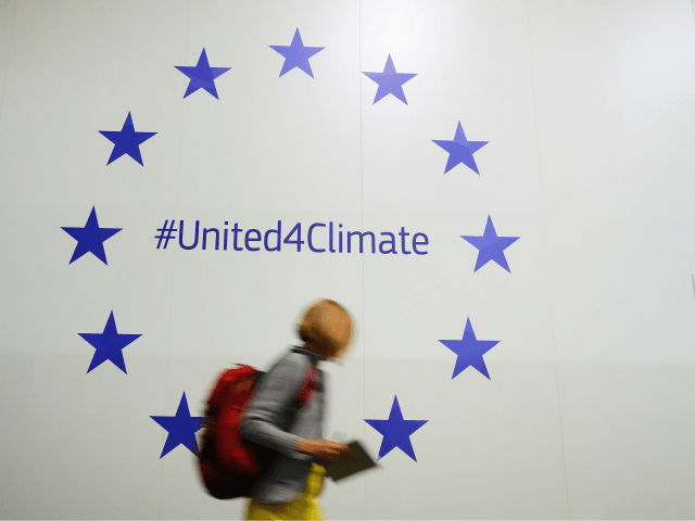 BONN, GERMANY - NOVEMBER 07: A participant walks past European Union stars advertising an EU social media climate intiative in Bonn Zone at the COP 23 United Nations Climate Change Conference on November 7, 2017 in Bonn, Germany. The conference brings together 25,000 participants to discuss climate change-related issues and …
