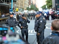 Officers watch over the scene outside the Time Warner Center on Wednesday, Oct. 24, 2018, in New York. Law enforcement officials say a suspicious package that prompted an evacuation of CNN's offices is believed to contain a pipe bomb.