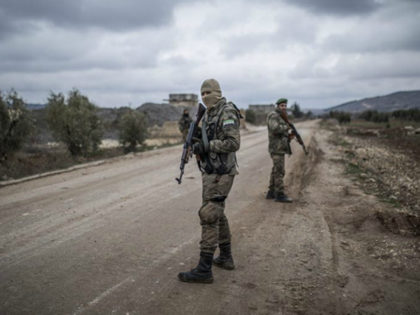 Turkey-backed Free Syrian Army fighters secure an area where the Turkish army's Operation Olive Branch continues in Azaz, northwestern Syria, Wednesday. (AP)