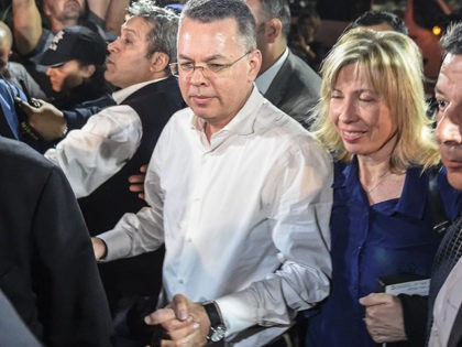 US pastor Andrew Craig Brunson (C,L) arrives at Adnan Menderes airport in Izmir, on October 12, 2018 after being freed following a trial in a court in Aliaga in western Izmir province. - US pastor Andrew Brunson, freed after a two-year detention in Turkey that shook relations between the countries, …