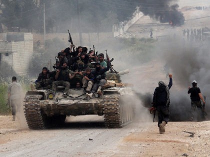 Fighters from a coalition of Islamist forces celebrate on May 19, 2015 after taking the Al
