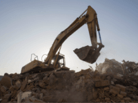GettyImages-901014786 In this picture taken on December 8, 2017, a bulldozer clears debris from buildings demolished by authorities in a migrant housing area on the outskirts of Beijing. The hundreds of millions of migrants who moved from the countryside to the cities may have fuelled China's dramatic economic boom of recent …
