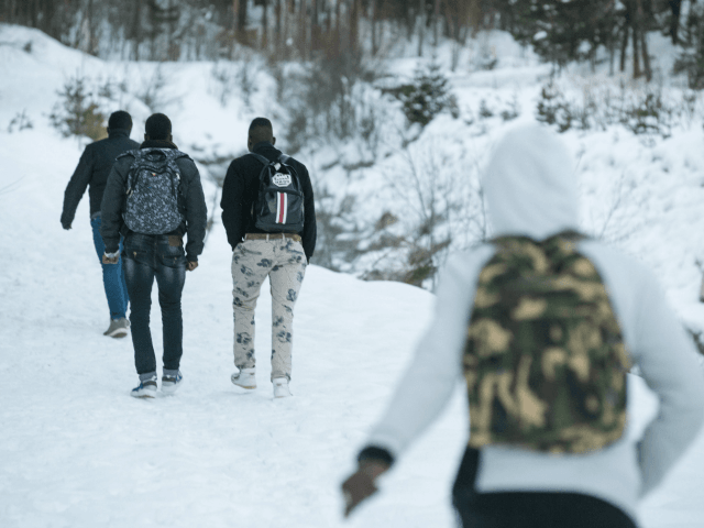 Migrants walk in the snow on their way to the Colle della Scala (Col de l'Echelle) a snow-covered pass to cross the border between Italy and France, on January 13, 2018 near Bardonecchia, Italian Alps. / AFP PHOTO / Piero CRUCIATTI (Photo credit should read PIERO CRUCIATTI/AFP/Getty Images)