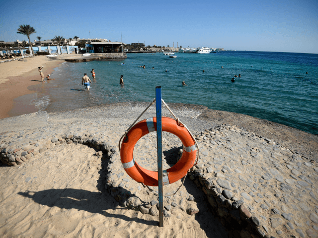 Tourists sunbathe at a beach in Egypt's Red Sea resort town of Hurghada on August 25, 2018
