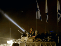 IDF israeli tank army armed forces Israel KISSUFIM CROSSING, GAZA STRIP - SEPTEMBER12: (ISRAEL OUT) An Israeli armored convoy leaves the through the Kissufim crossing as Israel ends its 38-year long occupation of the Palestinian territory early September 12, 2005 in the Gaza Strip, Gaza. Over 100 heavy military vehicles including tanks were seen passing through the …