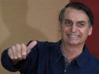 Brazil's right-wing presidential candidate for the Social Liberal Party (PSL) Jair Bolsonaro gives his thumb up after casting his vote during the general elections, in Rio de Janeiro, Brazil, on October 7, 2018. - Polling stations opened in Brazil on Sunday for the most divisive presidential election in the country …