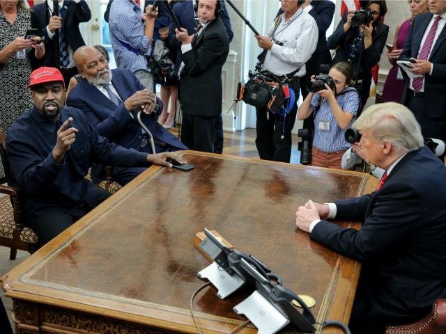 Rapper Kanye West, left, speaks during a meeting with U.S. President Donald Trump as NHL H