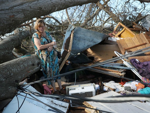 Kathy Coy stands among what is left of her home after Hurricane Michael destroyed it on October 11, 2018 in Panama City, Florida. She said she was in the home when it was blown apart and is thankful to be alive. The hurricane hit the Florida Panhandle as a category …