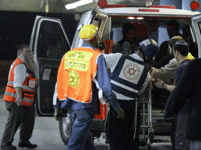 ISRAEL OUT A wounded man is wheeled into a hospital in Jerusalem following a shooting atta