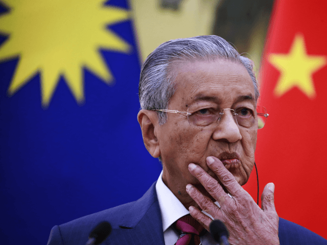 Malaysia Prime Minister Mahathir Mohamad gestures as he speaks to reporters during a press