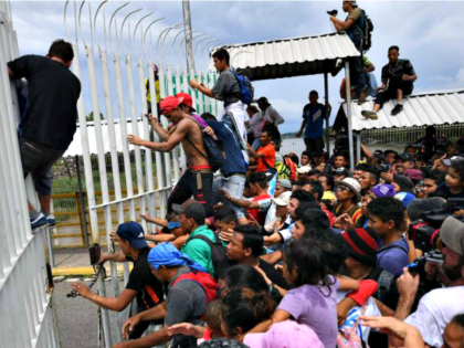 Migrants Break Through Border Fence