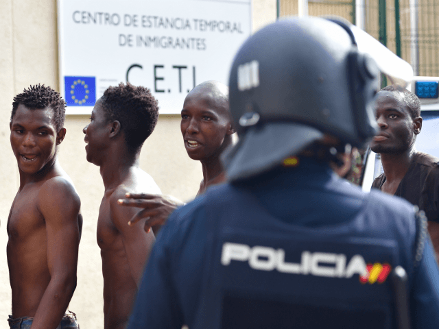 CEUTA, SPAIN - AUGUST 22: African migrants enter the Centre for Temporary Stay of Immigrants (CETI) after successfully breaching the border from Morocco into the Spanish exclave of Ceuta on August 22, 2018 in Ceuta, Spain. This morning 100-150 mostly sub-saharan refugees crossed the barb wire fence from Morocco into …