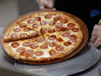 MIRAMAR, FL - NOVEMBER 18: Terry Cheung prepares a pizza pie to be served to students at Everglades High School on November 18, 2011 in Miramar, Florida. Monday evening the United States Congress passed a spending bill with a provision that would allow schools to count pizza as a vegetable. …