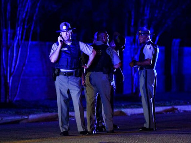 South Carolina state troopers gather on Hoffmeyer Road near the Vintage Place neighborhood where several law enforcement officers were shot, one fatally, Wednesday, Oct. 3, 2018, in Florence, S.C. (AP Photo/Sean Rayford)
