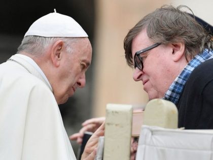 Pope Francis speaks with US documentary filmmaker Michael Moore at the end of the weekly general audience on October 17, 2018 at St. Peter's square in the Vatican. (Photo by Tiziana FABI / AFP) (Photo credit should read TIZIANA FABI/AFP/Getty Images)