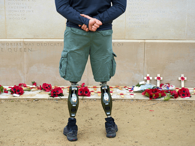 A member of the armed forces with prosthetic legs pays his respects at the Armed Forces Memorial in the National Memorial Arboretum on Armistice Day near Lichfield, Staffordshire, central England, on November 11, 2014. In services around the country tributes were paid to the millions of British servicemen and women …