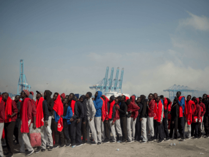 TOPSHOT - Migrants rescued at sea wait to be transferred at the harbour of Algeciras on Au