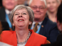 BIRMINGHAM, ENGLAND - SEPTEMBER 30: British Prime Minister Theresa May laughs as she sits in the audience during the annual Conservative Party Conference on September 30, 2018 in Birmingham, England. The Conservative Party Conference 2018 is taking place at Birmingham's International Convention Centre (ICC) from September 30 to October 3. …