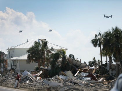 President Donald Trump makes a flyover as he tours the devastation caused by Hurricane Michael on October 15, 2018 in Mexico Beach, Florida. The hurricane hit the Florida Panhandle as a category 4 storm causing massive damage and claimed the lives of at least 17 people. (Photo by Joe Raedle/Getty …