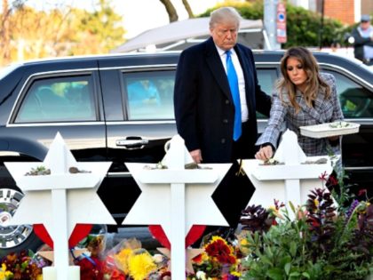 US President Donald Trump and First Lady Melania Trump place stones and flowers on a memorial as they pay their respects at the Tree of Life Synagogue in Pittsburgh, Pennsylvania, October 30, 2018. - Scores of protesters took to the streets of Pittsburgh to denounce a visit by US President …