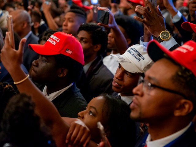 White House guests listen and take photographs as US President Donald Trump addresses the Young Black Leadership Summit at the White House on October 26, 2018 in Washington, DC. (Photo by Alex Edelman / AFP) (Photo credit should read ALEX EDELMAN/AFP/Getty Images)