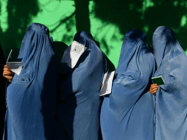 Afghan women wait in line to vote at a polling centre for the country's legislative electi