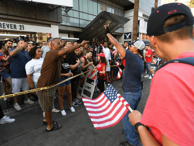 Trump supporters clash with anti-Trump crowd by the Trump Unity Bridge float parked by Trump star on the Walk of Fame in Hollywood on August 18, 2018. - The Trump Unity Float supporters met in Encino (15 miles NW of Hollywood) and caravaned on the 405 freeway, through some beach …